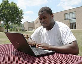 Male outside on laptop